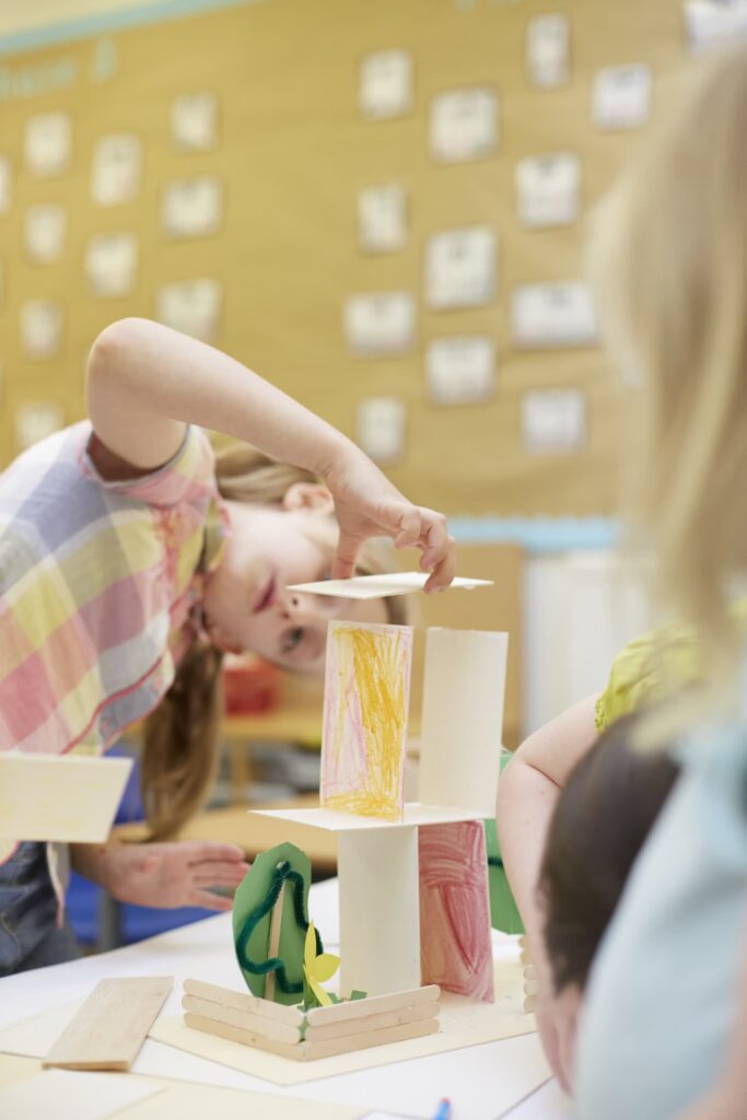 Children collaborating on a construction project in class