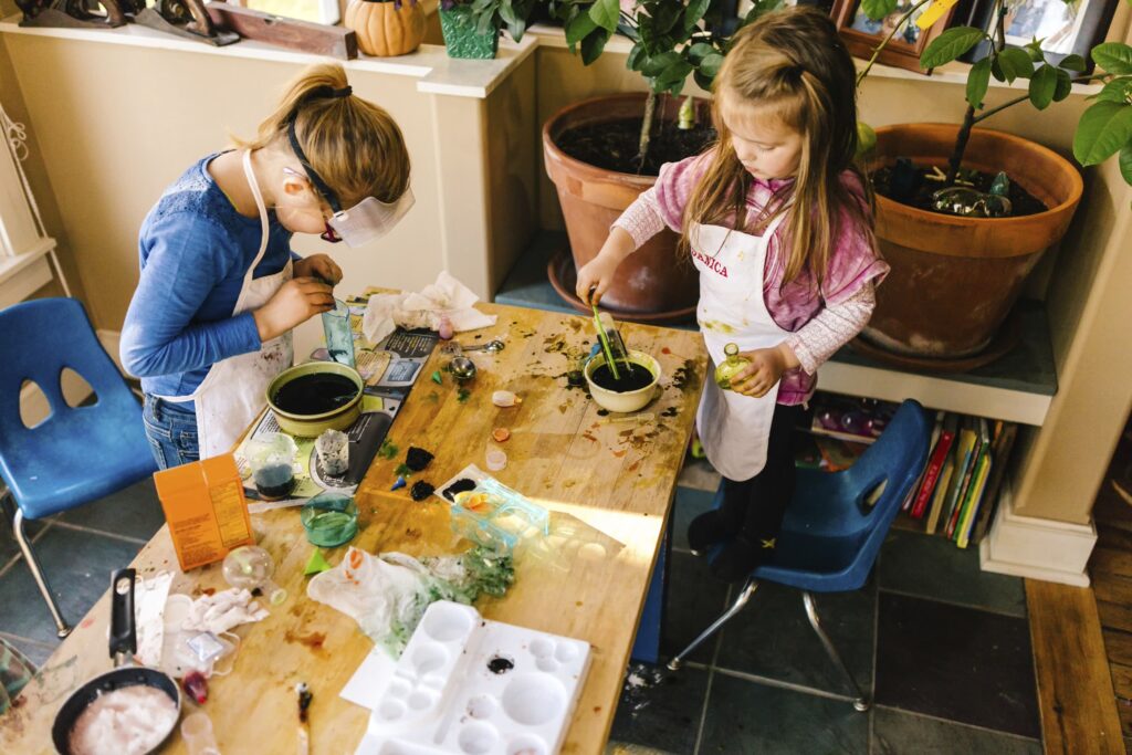 Girls doing a science experiment in a home classroom
